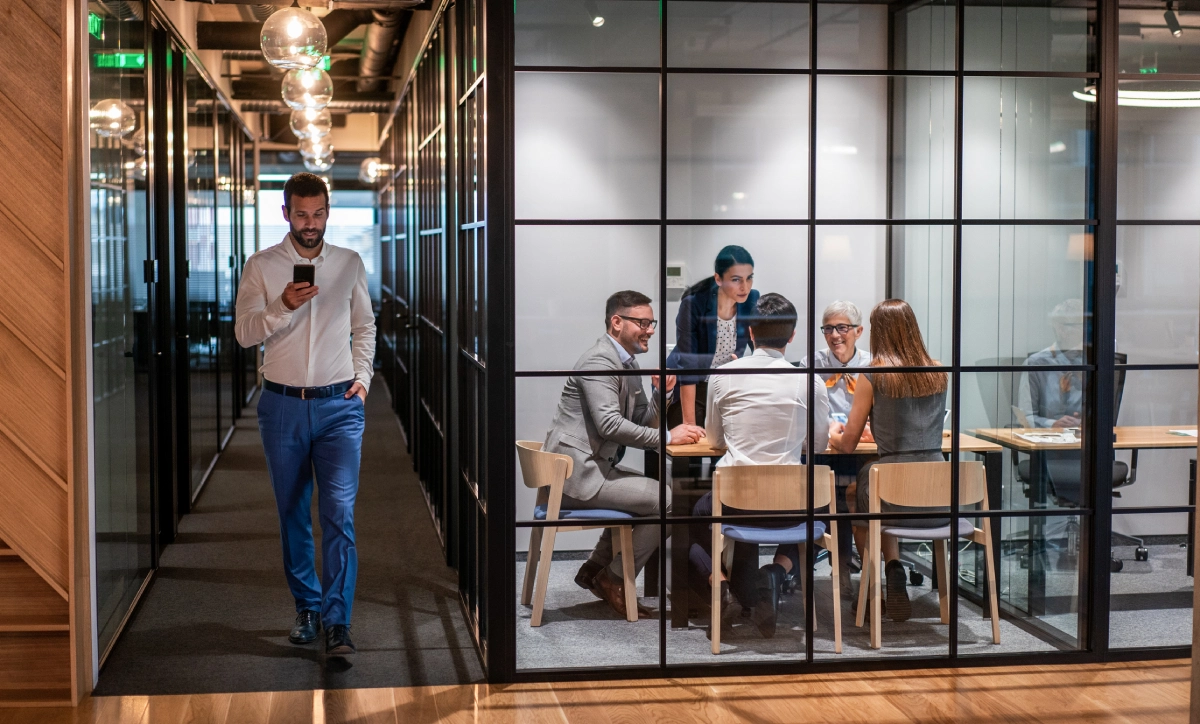 Office meeting in glass-walled conference room