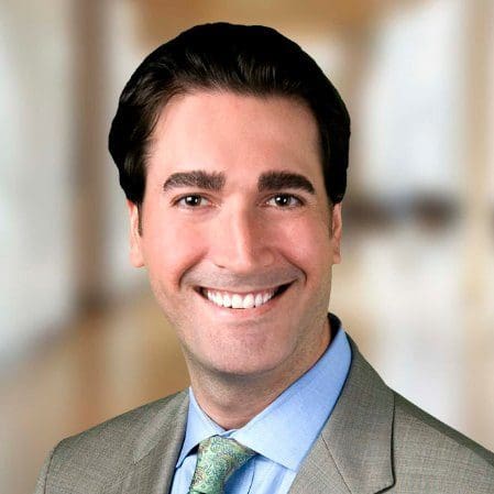 Smiling professional headshot in suit