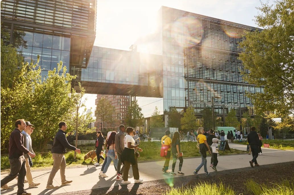Urban park walkway with glass skybridge and sun
